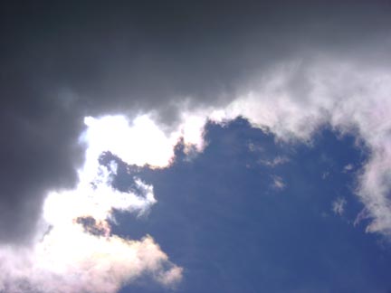 The Sun begins to break out from behind a dark cloud