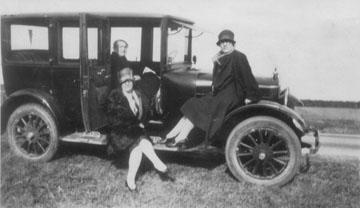 Sedan with Florence 'Ma' Jones, Aunt Bertie on fender and their mother in passenger seat.